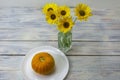 Still life on a wooden table yellow flowers and pumpkin. Light background, selective focus Royalty Free Stock Photo