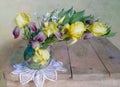 Still life with yellow irises in a glass vase on a table on a white background Royalty Free Stock Photo