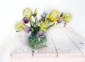 Still life with yellow irises in a glass vase on a table on a white background Royalty Free Stock Photo