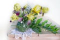 Still life with yellow irises in a glass vase on a table on a white background Royalty Free Stock Photo