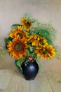 Bouquet with yellow and orange sunflowers in a clay vase on a white background Royalty Free Stock Photo