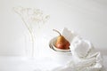 Still life with yellow-red pear Duchess in pile of bowls and a white embroidered napkin Royalty Free Stock Photo