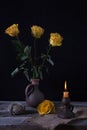 Still life with yellow withered flowers and candlestick with bur Royalty Free Stock Photo