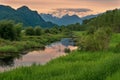 Still River Leading to Snow Capped Mountains