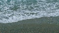 Soft Waves, With White Foam Are Washed Ashore. Wave Is Incident On The Beach Of Pebbles. Still. Royalty Free Stock Photo