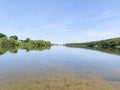 Still water of Staunton Harold Reservoir in Derbyshirew under a blue summer sky