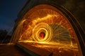 Still wool fire show under old arch in the night. Royalty Free Stock Photo