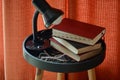 A stillfe of books, glasses and a lamp on a little round table. Royalty Free Stock Photo