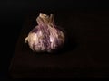 Stillife of garlic on a wooden table against a dark background