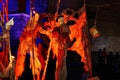 Stilt walkers with clay make up in front of the cathedral of Bremen at night