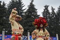 Stilt-walkers in traditional Ukrainian costumes pose for a photography during Shrovetide celebrations