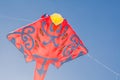 Stingray Kite design in red color flying on blue sky background. Royalty Free Stock Photo