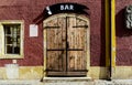 stipple textured exterior stucco wall elevation closeup. wood double wing gate