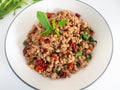 Stir fried basil with minced on a white plate,Thai food hot and spicy flavor. The ingredients are basil, garlic. Minced pork and C