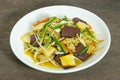 Stir Fried Bean Sprouts in white ceramic plate. Stir fried bean sprouts with yellow tofu, ground pork, carrots, pig`s blood and Royalty Free Stock Photo