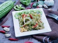 Stir-fried bitter gourd with eggs on wood background