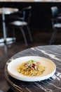 Stir fried Chinese noodle with ham and crab meat on black marble table top with blur background Royalty Free Stock Photo