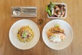 Stir fried Chinese noodle with ham and crab meat, Garlic fried rice with grilled salmon and Thick cut smoked ham spicy salad. Royalty Free Stock Photo