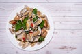 Stir fried Clams with roasted chili paste in white dish on the wood table. Royalty Free Stock Photo