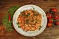 Stir-fried eggs and tomatoes served in armenian restaurant decorated with chili pepper, greens and cherry tomatoes