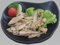 Stir-fried eryngii mushrooms with sesame oil in black plate-Food ingredients concept