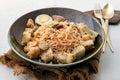 Stir fried instant noodles with green curry with chicken Kaeng khiao wan and Boiled egg in sweet brown sauce in ceramic bowl Royalty Free Stock Photo