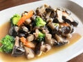 Stir fried mushroom with broccoli carrot vegetable, shiitake mushrooms with oyster sauce cooking food on white plate, shiitake Royalty Free Stock Photo
