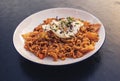 Stir fried noodles with fried egg topped with white sesame seeds and seaweed