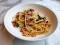 Stir-fried pasta linguine with dried chili and crispy bacon Royalty Free Stock Photo