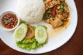 Stir-fried pork with basil and rice with chopped chili in fish sauce