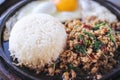 Stir fried pork with thai basil ,white rice and fried egg Khao pad krapow in black hot pan on table food background Royalty Free Stock Photo