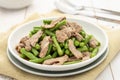 Stir-fried pork with yardlong beans served on the white plate Royalty Free Stock Photo