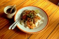 Stir fried prawns with garlic and Thai chili topped with rice