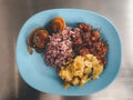 Stir-fried pumpkin eggs, fried preserved egg and stir-fried chicken with red curry paste served with riceberry