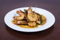 Stir fried red curry with shrimp Thai food on a wooden background