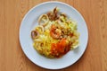 Stir fried rice noodle seafood and egg dressing chili sauce on dish