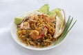 Stir Fried Rice Noodle Thai style with Prawns and side dishes or Thai people call Pad thai in white plate. Royalty Free Stock Photo