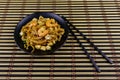 Stir fried rice noodles Pad Thai with prawns and tofu in plate on bamboo mat. Thai food Royalty Free Stock Photo