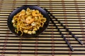 Stir fried rice noodles Pad Thai with prawns and tofu in plate on bamboo mat. Thai food Royalty Free Stock Photo