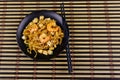 Stir fried rice noodles Pad Thai with prawns and tofu in plate on bamboo mat. Top view. Thai food Royalty Free Stock Photo