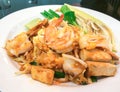 Stir-fried Rice Noodles with Shrimp and Squid in White Plate Royalty Free Stock Photo