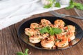 Stir-fried Shrimp with pepper and garlic on black plate. Royalty Free Stock Photo