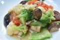 Stir fried slice cauliflower with broccoli and mixed vegetable couple pork on plate