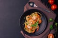 Stir-fried spaghetti or stir-fried noodles Tomato sauce and prawns on a black plate On a wooden table background. Top view Royalty Free Stock Photo