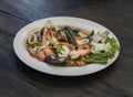 Stir-Fried Spicy seafood with herbs and spices served on white plate. Authentic thai food