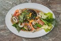 Stir-Fried Spicy seafood with herbs and spices served on white plate. Authentic thai food