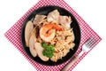 Stir fried spicy spaghetti with shrimp, clam, sausage, ham and dried chili on black plate. Royalty Free Stock Photo