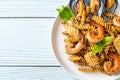 Stir-fried spiral pasta with seafood and basil sauce Royalty Free Stock Photo