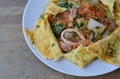 Stir fried sukiyaki with seafood wrapped in egg on dish Royalty Free Stock Photo