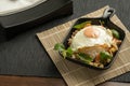 Stir-fried Thai basil with minced pork meat, carrots, and baby corns, with fried egg and fresh Thai basils sort in a black small Royalty Free Stock Photo